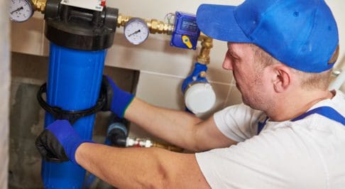 plumber working on a water filter