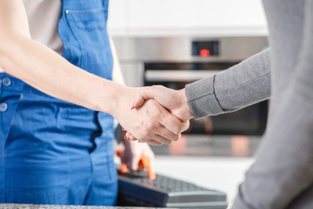 contractor shaking hand of customer after services 